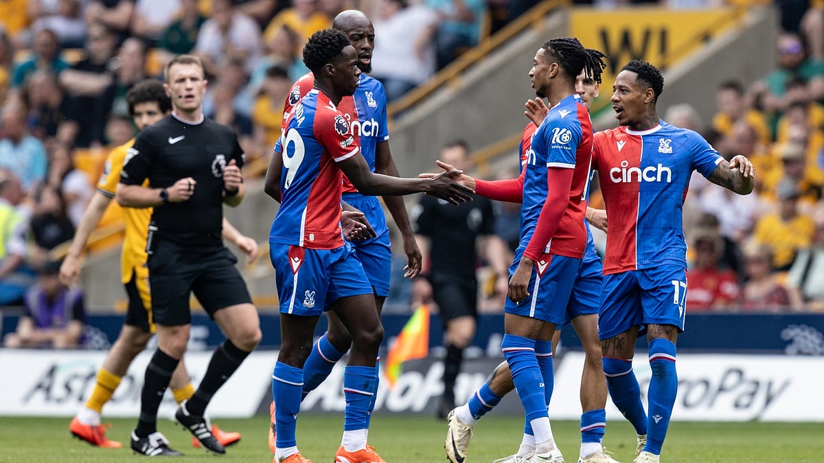Michael Olise celebrates after opening the scoring at Molineux.