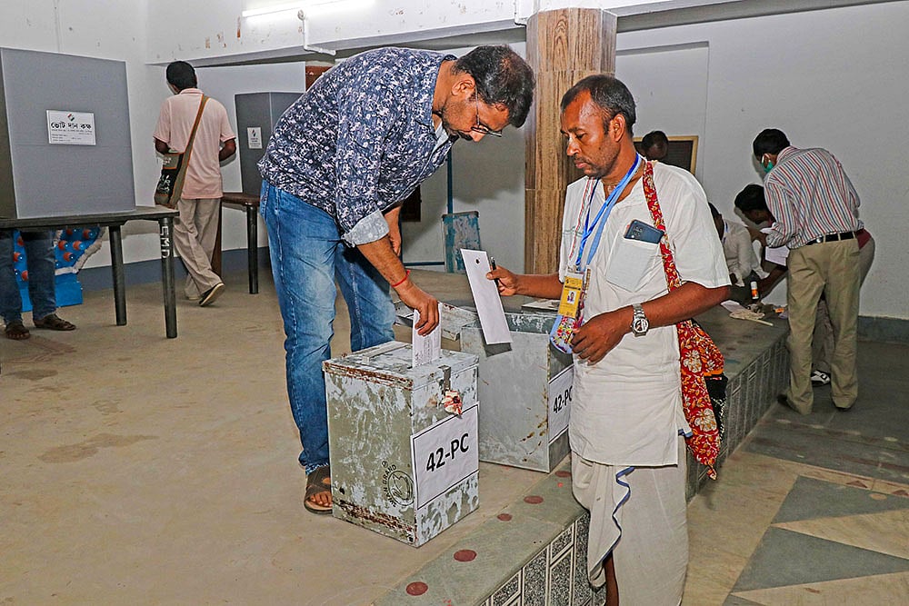 Polling officials cast vote