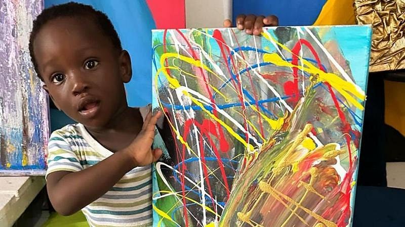 X : Ace-Liam with his painting.