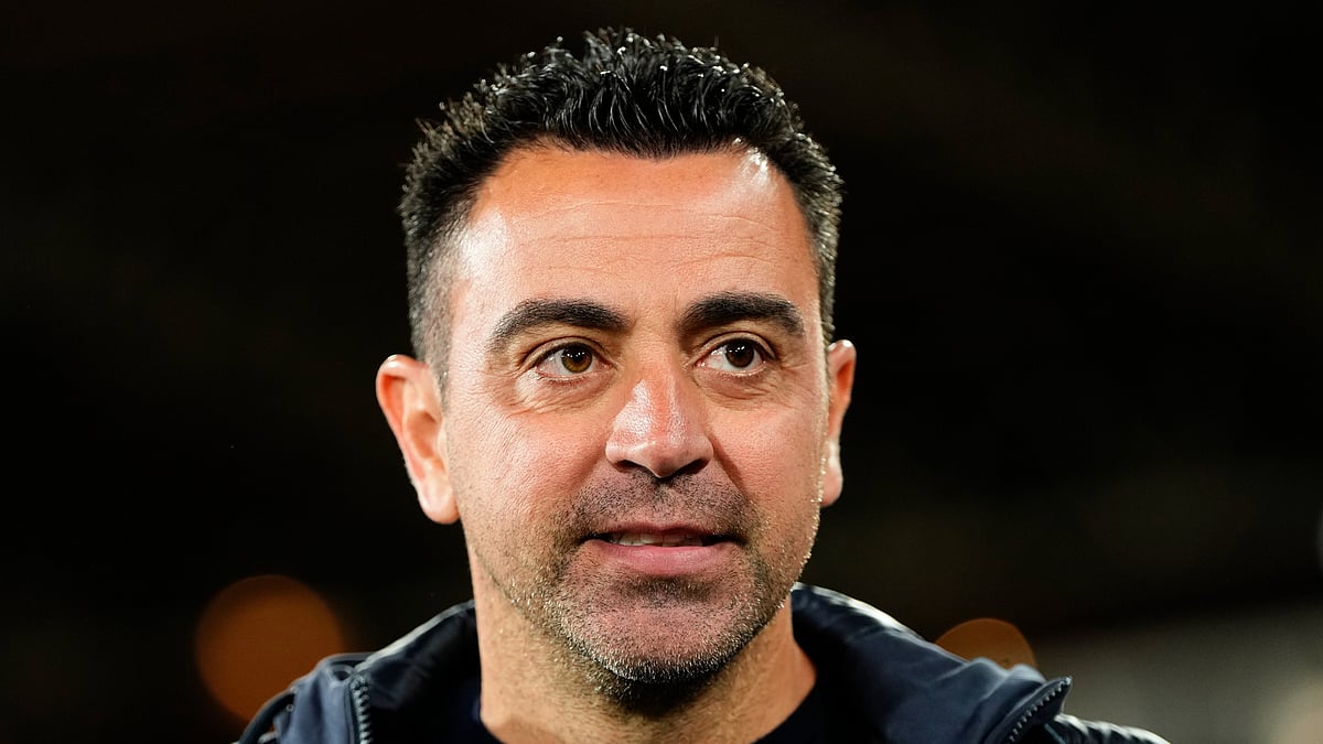 AP Photo/Jose Breton : Barcelona's head coach Xavi Hernandez walks to his seat before a Spanish La Liga soccer match between Almeria and Barcelona at the Power Horse stadium in Almeria.