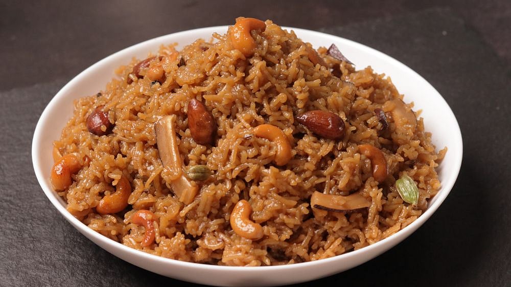 A bowl of Gur wale Chawal - rice with nuts and cashews, a delicious and nutritious meal option.
