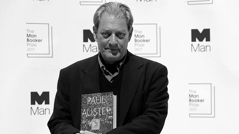 U.S. author Paul Auster poses with his book "4321" during a photocall with all six shortlisted authors of the 2017 Man Booker Prize for Fiction, in London, Oct. 16, 2017. - AP