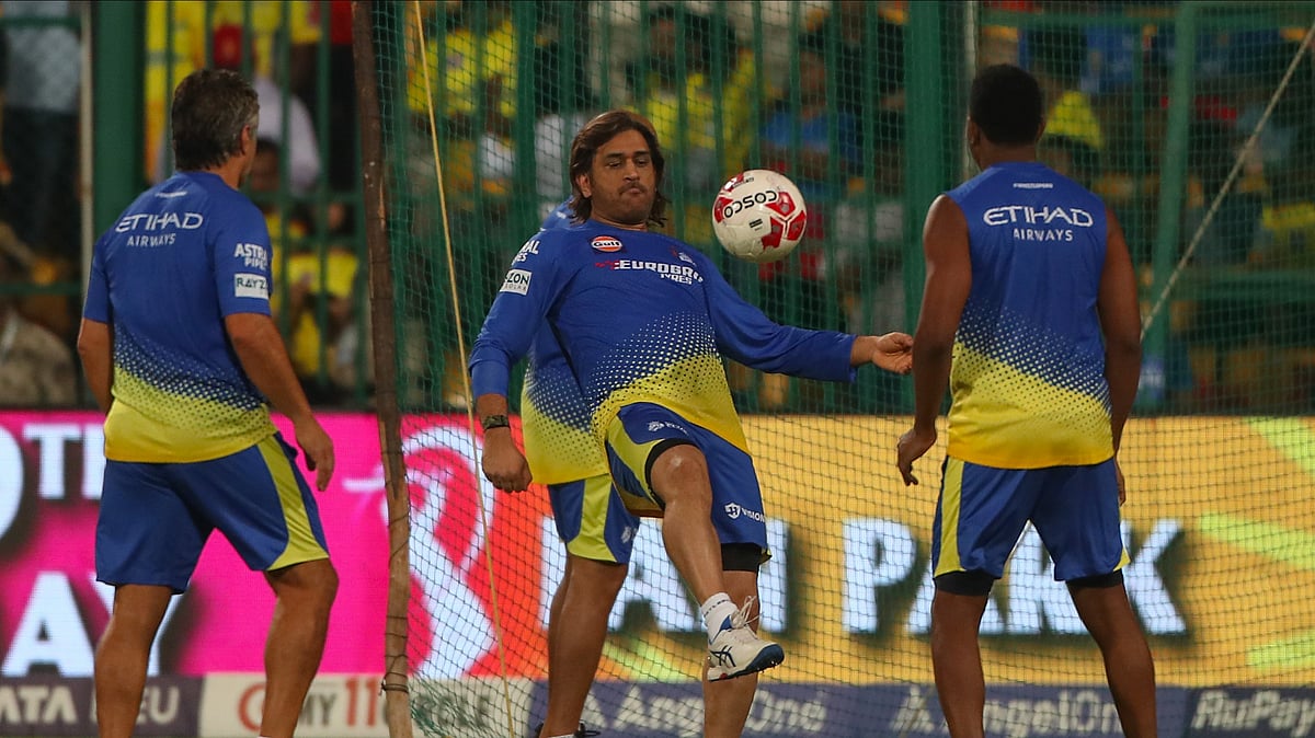 Chennai Super Kings MS Dhoni, centre, warms up before the start of the Indian Premier League cricket match between Royal Challengers Bengaluru and Chennai Super Kings in Bengaluru. - AP Photo/Kashif Masood
