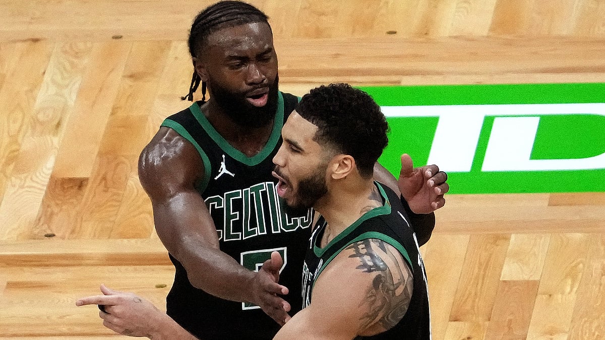 Boston Celtics guard Jaylen Brown holds back Boston Celtics forward Jayson Tatum.