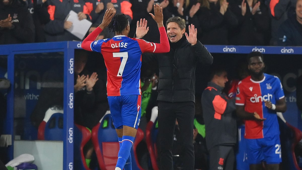 Michael Olise celebrates with Oliver Glasner.