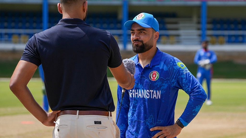 X/Afghanistan Cricket Board : Afghanistan captain Rashid Khan at the toss for their ICC T20 World Cup 2024 warm-up match against Oman on Wednesday (May 29).
