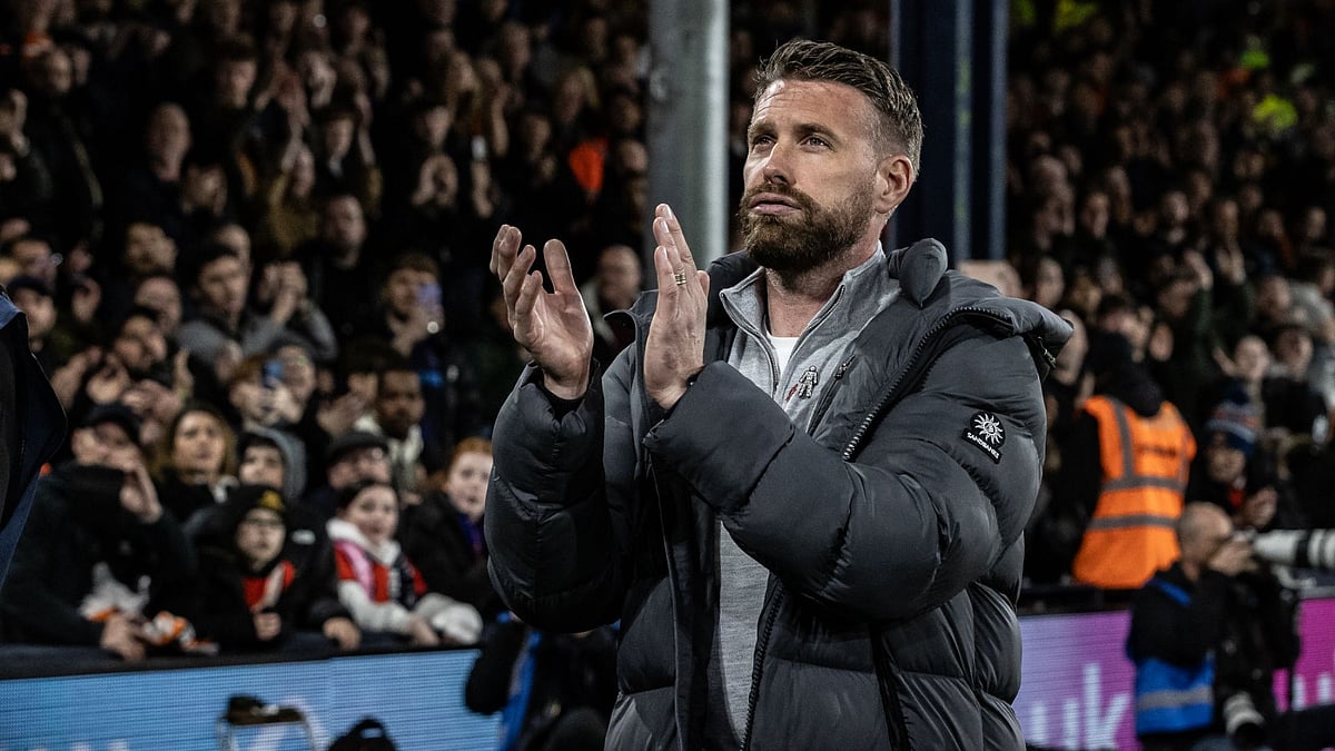 Rob Edwards applauds Luton's fans at Kenilworth Road.