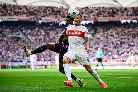 Alphonso Davies, left, vies for the ball with Jamie Leweling,