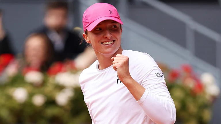 Iga Swiatek celebrates after clinching her win over Madison Keys - null