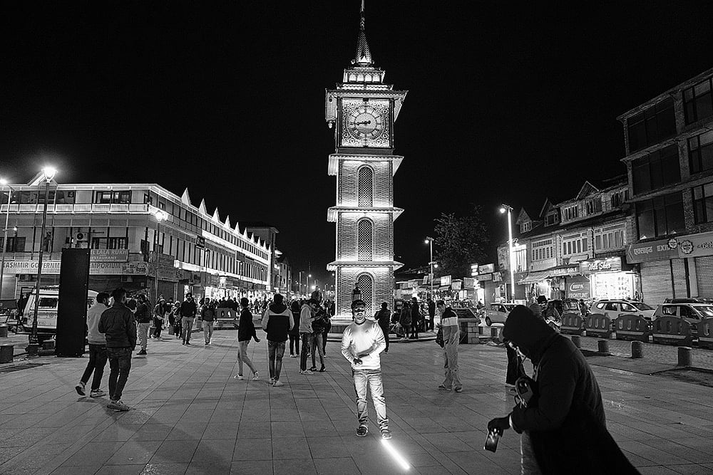 Photo: Manpreet Romana : Changing Times: A tourist takes images in front of the clock tower in Lal Chowk