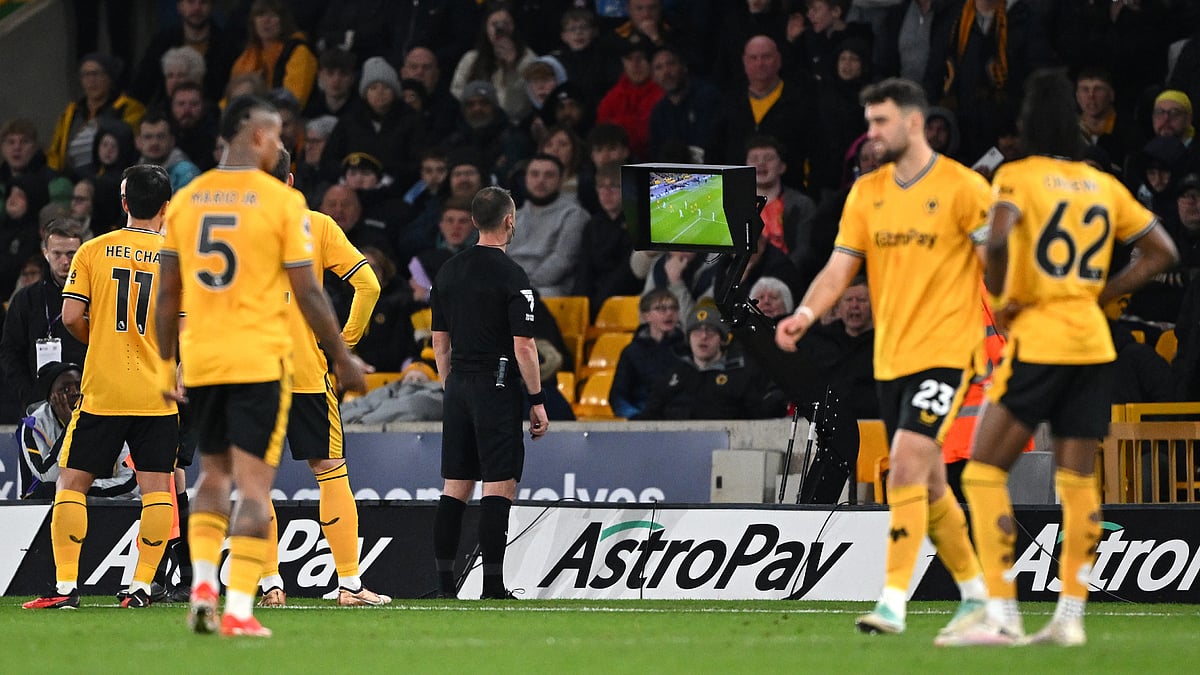 Stuart Attwell goes to the VAR monitor to disallow a Wolves goal against Bournemouth.