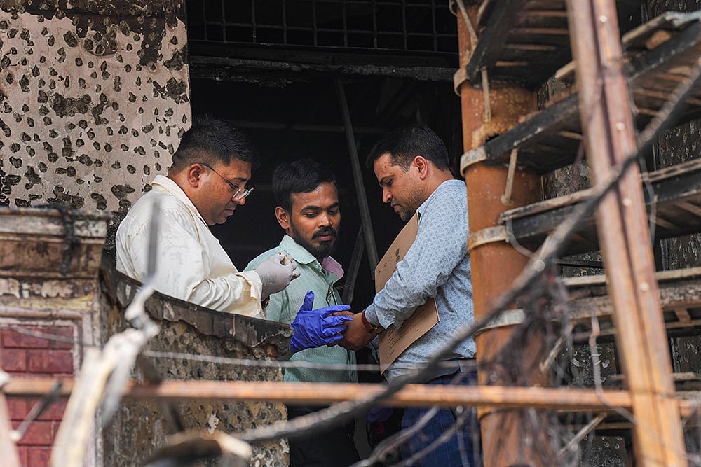 Forensic officials at Vivek Vihar hospital site