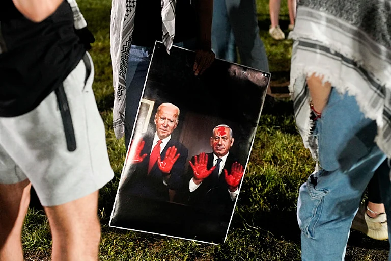 Pro-Palestinian protesters hold a sign depicting President Joe Biden and Israeli Prime Minister Benjamin Netanyahu with blood on their hands, on the campus of Ohio State University on May 1, 2024 in Columbus, Ohio. Protesters returned after 36 were arrested participating earlier in the week as campuses across the country continued demonstrating against Israel's conduct of the war in Gaza. - Andrew Spear/Getty Images