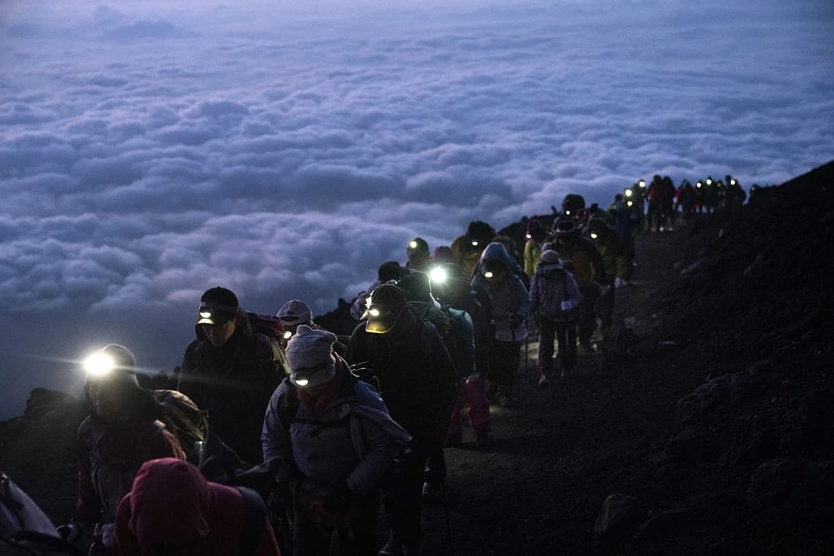 AP : Group of mountaineers on the top of Mount Fuji