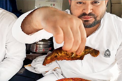 Tejashwi Yadav holding fried fish
