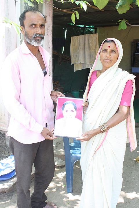 Ashok Rohate and his mother Malanbai holding photo of wife Rahi Rohate from Ahervadgaon village, who committed suicide in May