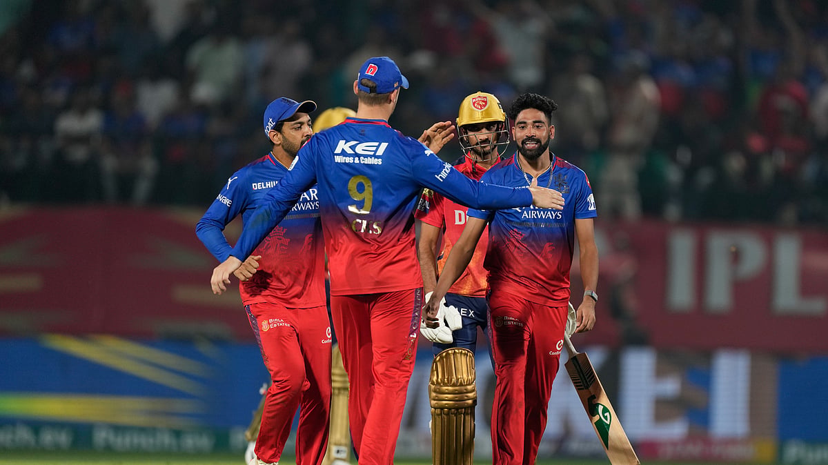 RCB players celebrating a wicket of PBKS batter in IPL 2024. AP Photo