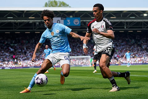 Oscar Bobb, left, challenges with Antonee Robinson