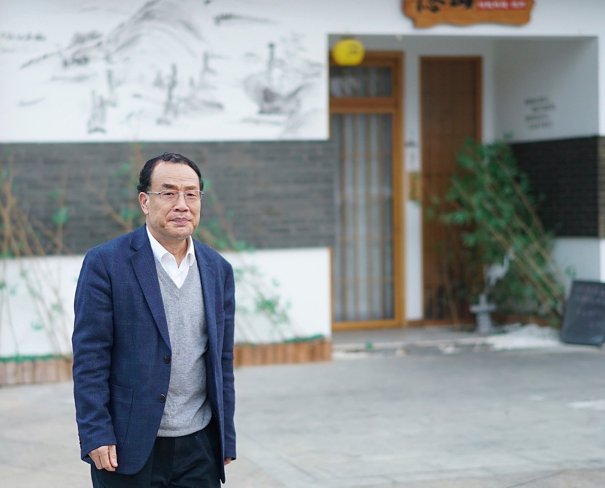 AP : Virologist Zhang Yongzhen, the first scientist to publish a sequence of the COVID-19 virus, walks down a street in Shanghai, China on Dec. 13, 2020. 
