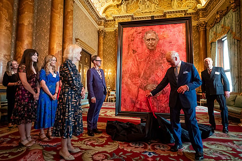 Britain's King Charles III and Queen Camilla at the unveiling of artist Jonathan Yeo's portrait of the King, in the blue drawing room at Buckingham Palace, in London, Tuesday May 14, 2024. The portrait was commissioned in 2020 to celebrate the then Prince of Wales's 50 years as a member of The Drapers' Company in 2022. The artwork depicts the King wearing the uniform of the Welsh Guards, of which he was made Regimental Colonel in 1975. 