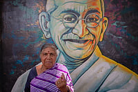 Women In Karnataka: The Silent Vote Bank Getty Images : K. S. Gowramma, 65, stands in front of a mural of Indian freedom fighter Mohandas Karamchand Gandhi and shows her finger marked with indelible ink after voting in the second phase of the general elections on April 26, 2024 in Bengaluru, India.