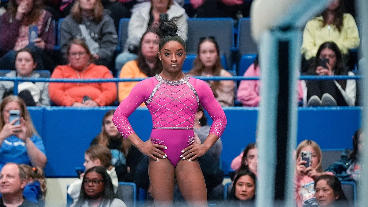 Simone Biles prepares to compete on the balance beam during the U.S. Classic gymnastics event. - AP