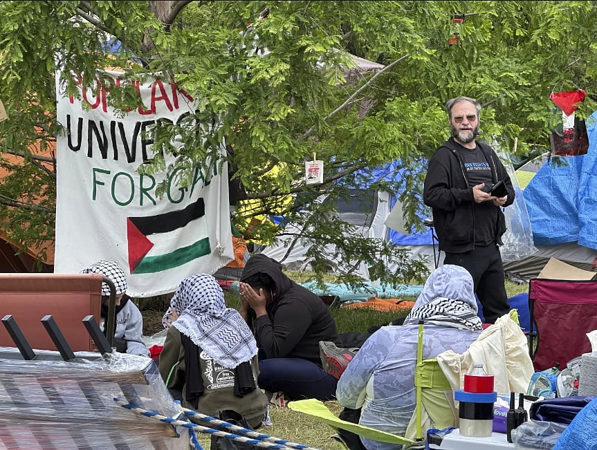 AP : Television footage showed campus police and Detroit police officers in riot gear tearing down fencing before they removed the protesters and started breaking down tents |