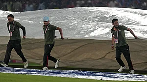 AP/Ashwini Bhatia : Covers being brought on in Dharamsala during the IPL 2024 match between Punjab Kings and Royal Challengers Bengaluru.