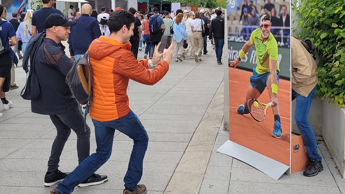 A French fan poses with a life-sized cardboard cutout of Rafael Nadal next to Roland Garros main stadium, Tuesday, May 21, 2024 in Paris. The French Open tennis tournament start Sunday May 26th. - AP