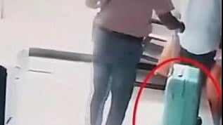 X/@PTI_News : CCTV footage of two men walking out of the apartment while one of them was carrying a large suitcase |