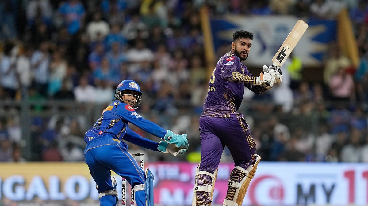 Kolkata Knight Riders' Venkatesh Iyer plays a shot as Mumbai Indians' Ishan Kishan watches during the Indian Premier League cricket match between Mumbai Indians and Kolkata Knight Riders in Mumbai. - AP Photo/Rajanish Kakade