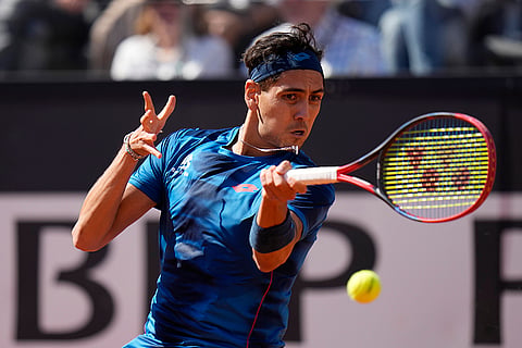 Alejandro Tabilo returns the ball to Djokovic