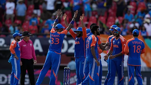 AP Photo/Ramon Espinosa : Indian players celebrate a dismissal during the ICC Mens T20 World Cup second semifinal cricket match between England and India at the Guyana National Stadium in Providence, Guyana.