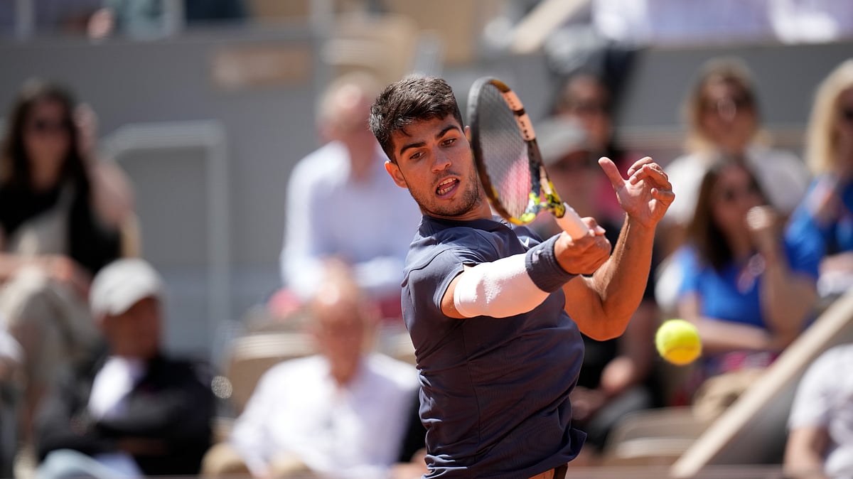 Christophe Ena/AP : Spain's Carlos Alcaraz plays a shot against Jeffrey John Wolf of the United States during their first-round match of the French Open 2024 at the Roland Garros Stadium in Paris on May 26, 2024.