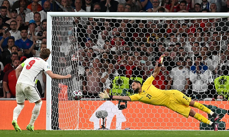 FILE - England's Harry Kane left, shoots to score past Italy's goalkeeper Gianluigi Donnarumma during penalty shootout of the Euro 2020 soccer championship final match between England and Italy at Wembley Stadium in London, Sunday, July 11, 2021. The penalty shootout is a tense battle of wills over 12 yards (11 meters) that has increasingly become a huge part of soccer and an unavoidable feature of the knockout stage in the biggest competitions. - (Paul Ellis/Pool via AP, File)