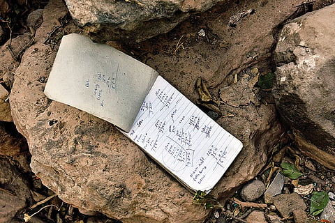 A notebook with scribbles by an unknown person found at the site