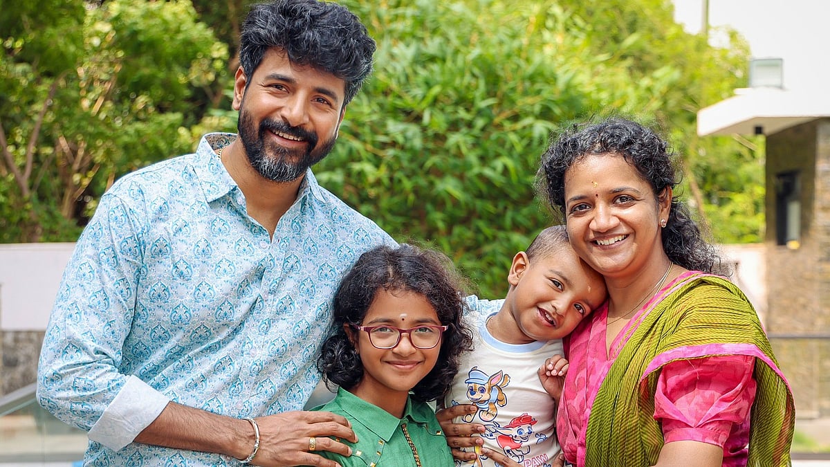 X : Sivakarthikeyan with his wife Arathy and kids