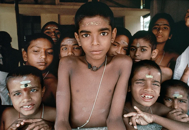 Boys from the Brahmin caste crowd around for a photo - Getty Images