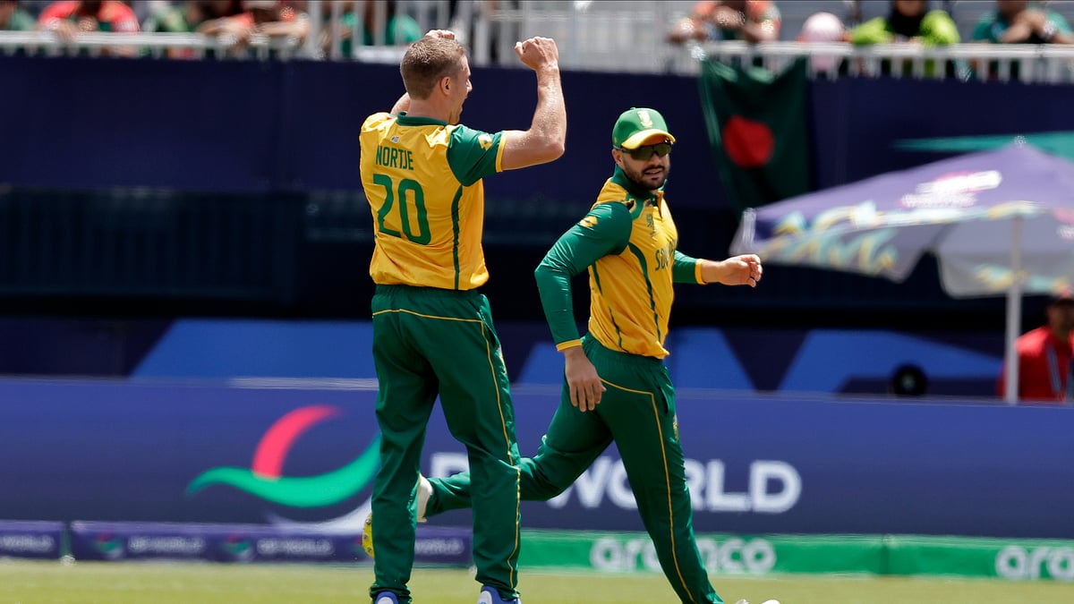 AP Photo/Adam Hunger : South Africa's Anrich Nortje, left, celebrates with captain Aiden Markram after the dismissal of Bangladesh's captain Najmul Hossain Shanto during the ICC Men's T20 World Cup cricket match between Bangladesh and South Africa at the Nassau County International Cricket Stadium in Westbury, New York.