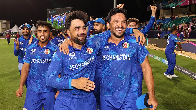 Rashid Khan and Gulbadin Naib celebrate Afghanistan reaching the T20 World Cup semi-finals. - null
