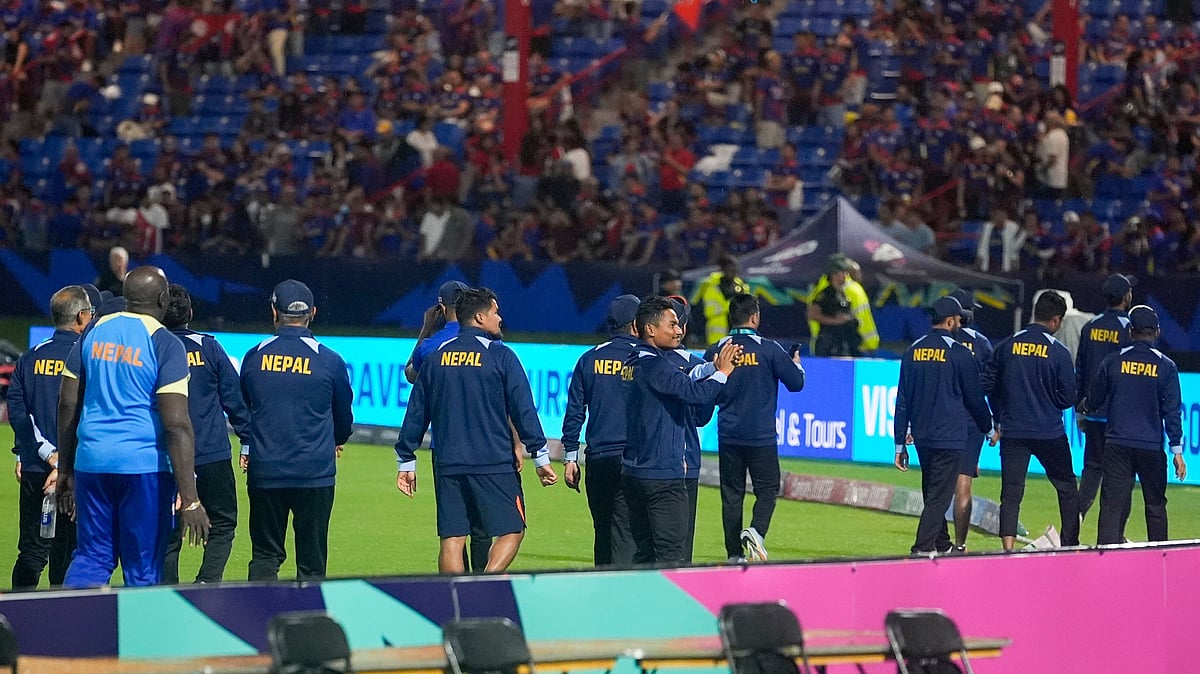Photo: AP/PTI : Nepal players walk around the field and gesture to fans after their men's T20 World Cup cricket match against Sri Lanka was abandoned due to rain at Central Broward Regional Park Stadium, Lauderhill.
