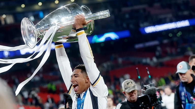 Jude Bellingham holds the Champions League trophy aloft. - null