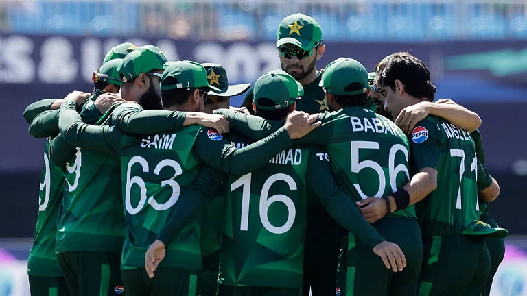 Pakistan players huddle before the start of the ICC Men's T20 World Cup cricket match between Pakistan and Canada at the Nassau County International Cricket Stadium in Westbury, New York, Tuesday, June 11, 2024. - (AP Photo/Adam Hunger)