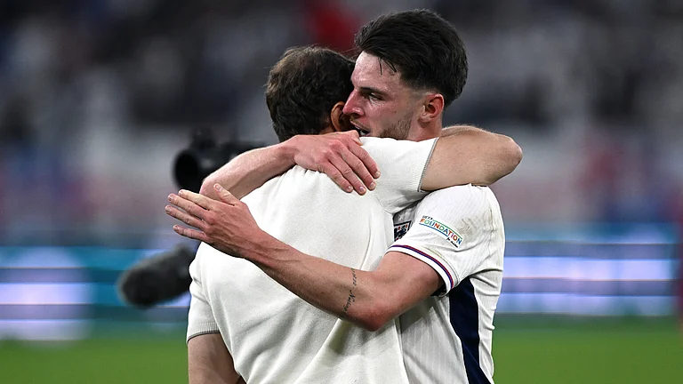 Declan Rice shares an embrace with England manager Gareth Southgate on Sunday. - null
