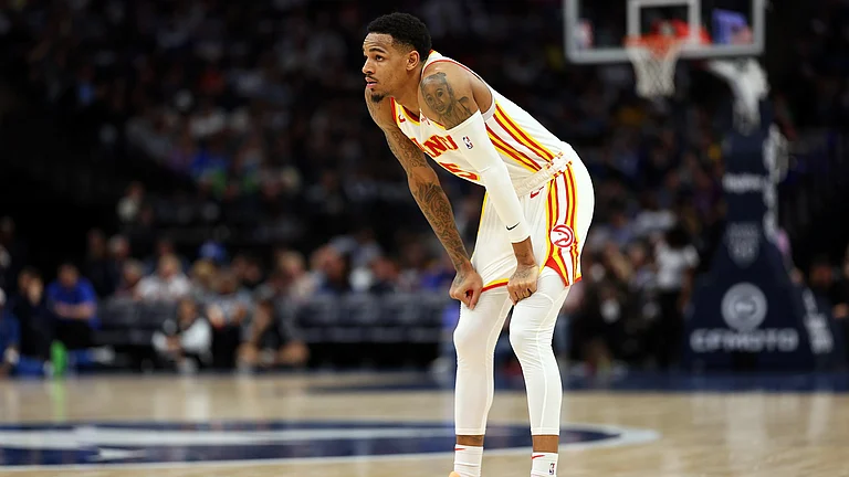 Dejounte Murray of the Atlanta Hawks looks on against the Minnesota Timberwolves in the third quarter at Target Center on April 12, 2024 in Minneapolis, Minnesota. - null