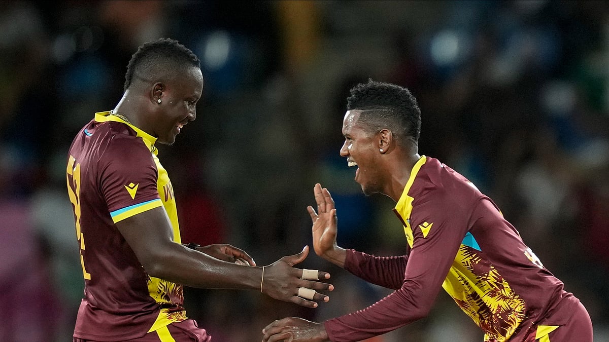 AP Photo/Ramon Espinosa : West Indies captain Rovman Powell, left, celebrates with bowler Akeal Hosein the dismissal of Afghanistan's Karim Janat during an ICC Men's T20 World Cup cricket match at Daren Sammy National Cricket Stadium in Gros Islet, Saint Lucia.
