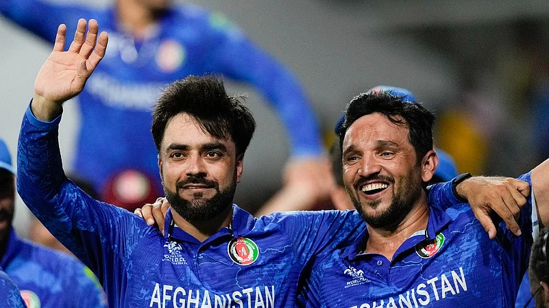 Rashid Khan and Gulbadin Naib celebrate Afghanistan win over Bangladesh and semifinal entry, ICC T20 World Cup 2024, AP photo