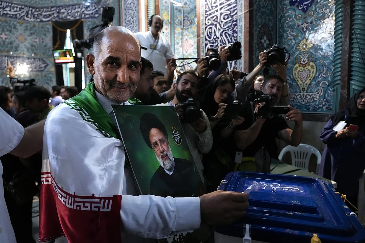 AP : A man cast his ballot during the presidential election at a polling station in Tehran |