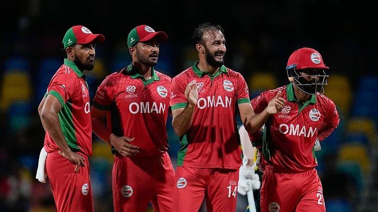 Oman's Mehran Khan, second right, celebrates after taking the wicket of Australia's Glenn Maxwell during an ICC Men's T20 World Cup cricket match at Kensington Oval in Bridgetown, Barbados, Wednesday, June 5, 2024. - (AP Photo/Ricardo Mazalan)