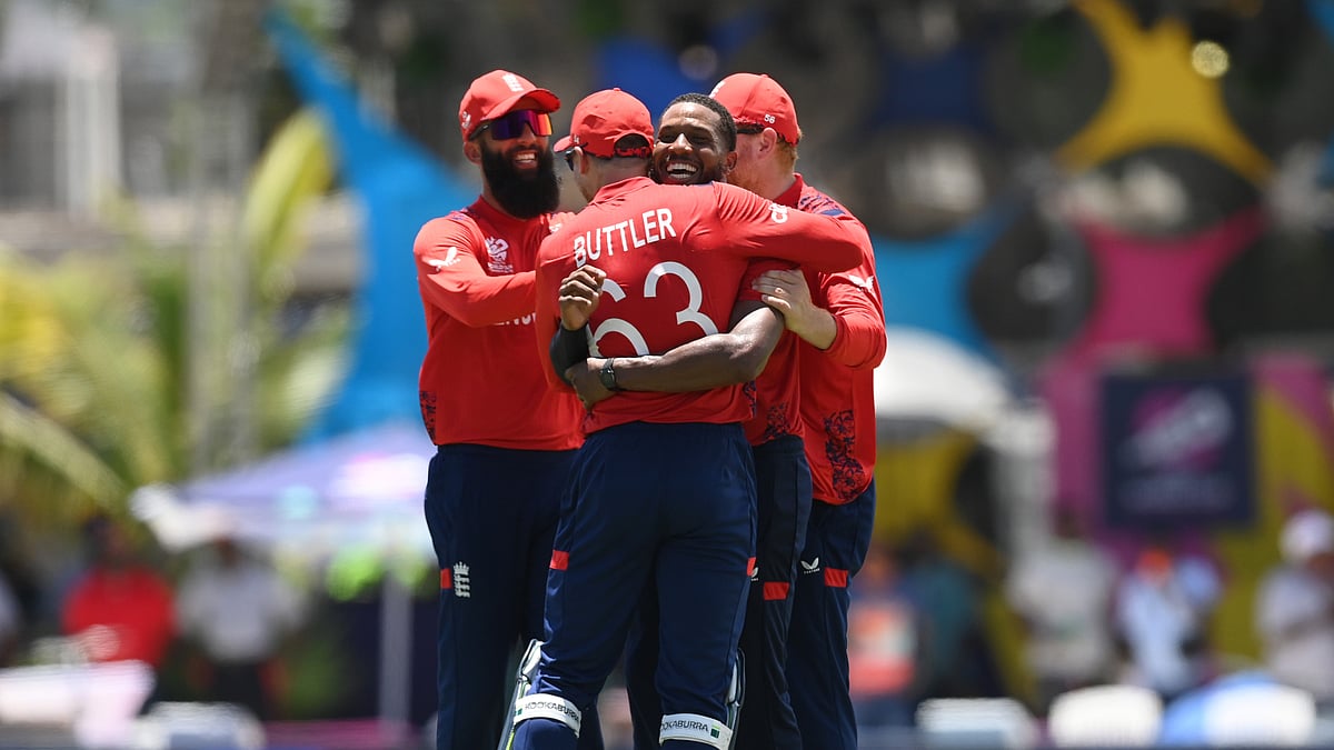 Jos Buttler and Chris Jordan celebrate the latter's hat-trick on Sunday.